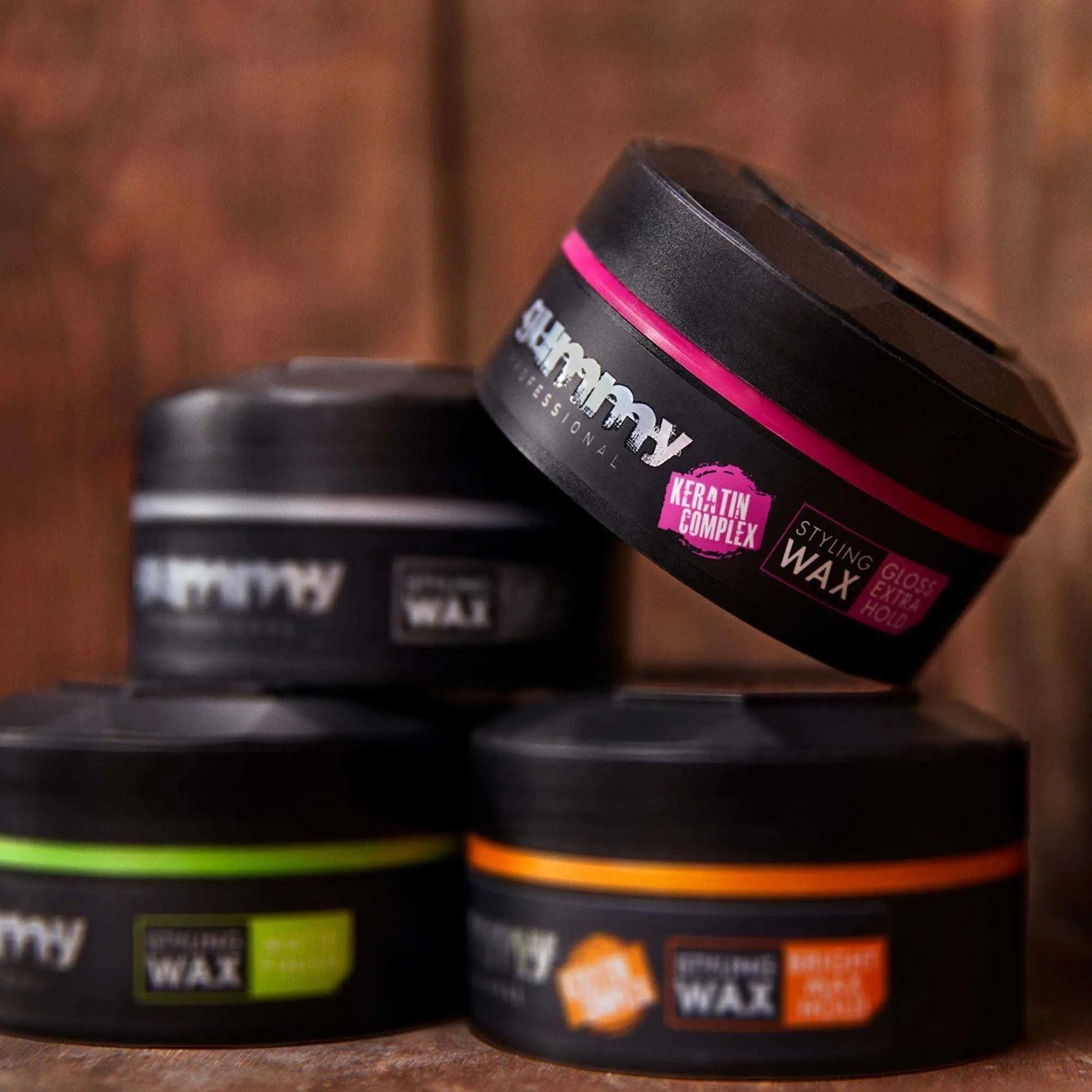 Gummy Styling Wax 150ml Gloss Extra Hold with Keratin Complex displayed on wooden background.