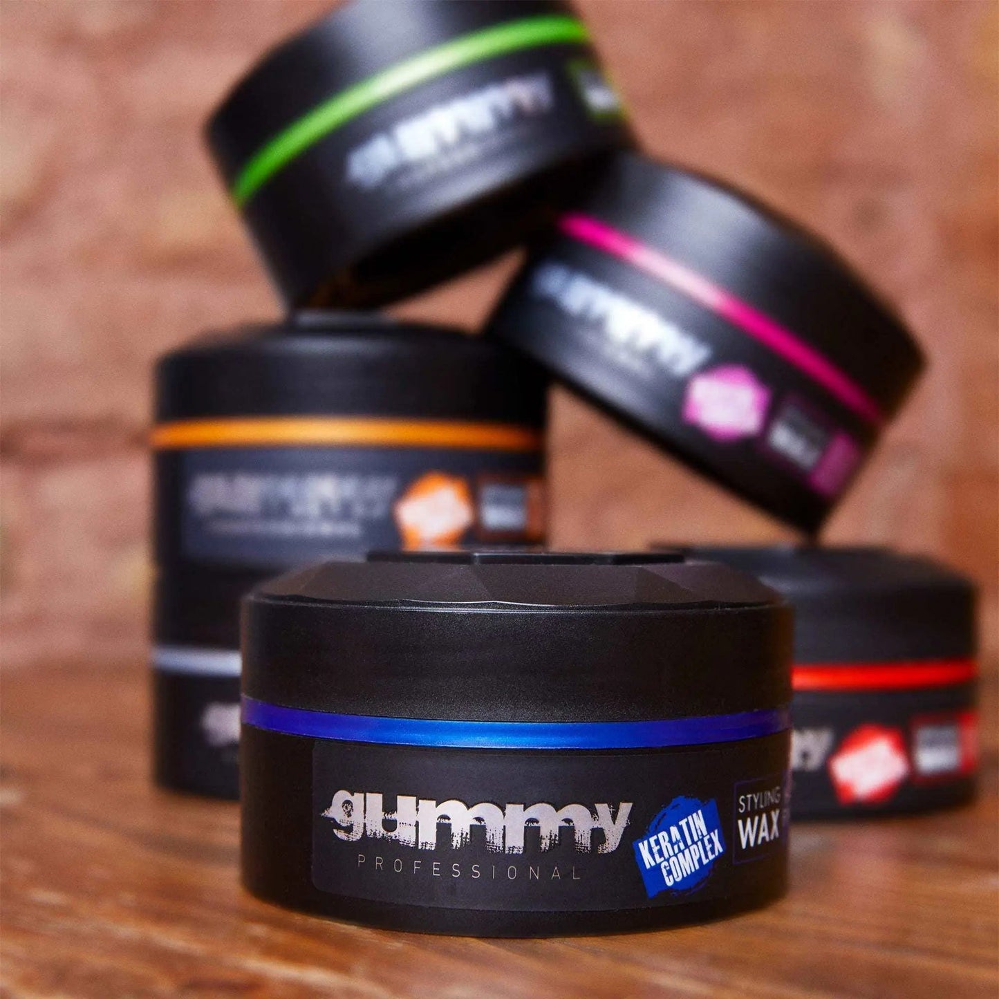 Gummy Styling Wax 150 ml containers with hard finish on a wooden surface.